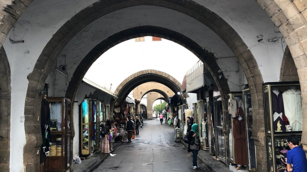 Moorish archways and traditional artisan shops lining a quiet street in the Habous Quarter, Casablanca, Morocco