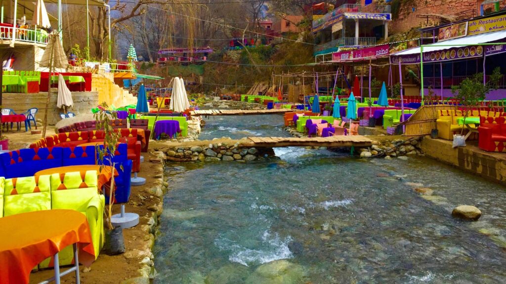 Colorful riverside restaurants along the Ourika Valley river on a day trip from Marrakech