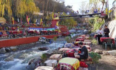 Tourist relaxing at a traditional riverside cafe in Setti Fatma during an Ourika Valley day trip from Marrakech