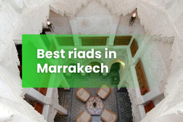 Riads in Marrakesh - Interior courtyard of a luxury riad in Marrakech with ornate Moroccan plasterwork and zellige tiles