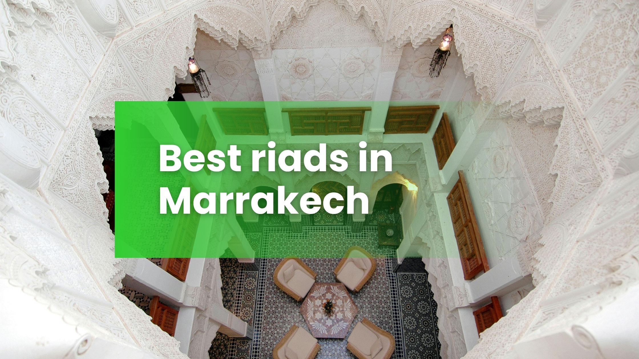 Riads in Marrakesh - Interior courtyard of a luxury riad in Marrakech with ornate Moroccan plasterwork and zellige tiles